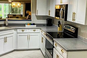 Fridge, microwave, oven, stovetop - Lakefront getaway with walk-out lanai, pool, tennis/Bocce courts & marina (North Naples)