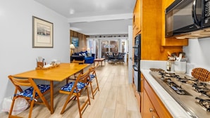 A compact kitchen with a dining area, wooden cabinets, and a built-in microwave. - 25% Off Sept WkDays Great 4 Families, Walk 2 Beach (Ventura)
