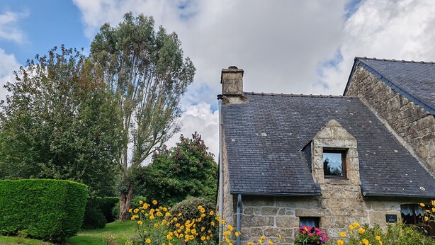 A stone house with a sloped roof, a small window, and a gravel path leading to it. - Delightful 1-bedroom cottage in tranquil Sainte Price Melrand perfect getaway (Melrand)