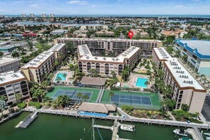 A hotel with multiple buildings, a marina, tennis courts, and a pool. - Snowbird-friendly condo with hot tub, outdoor pool, tennis, dock, BBQ, & balcony (Marco Island)