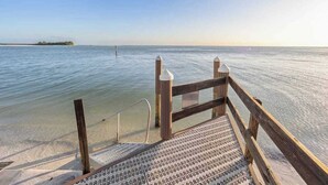 A wooden pier leading into calm waters with a distant island. - Spacious oceanfront condo with heated pool, pickleball, tennis, gym, & balcony (Marco Island)