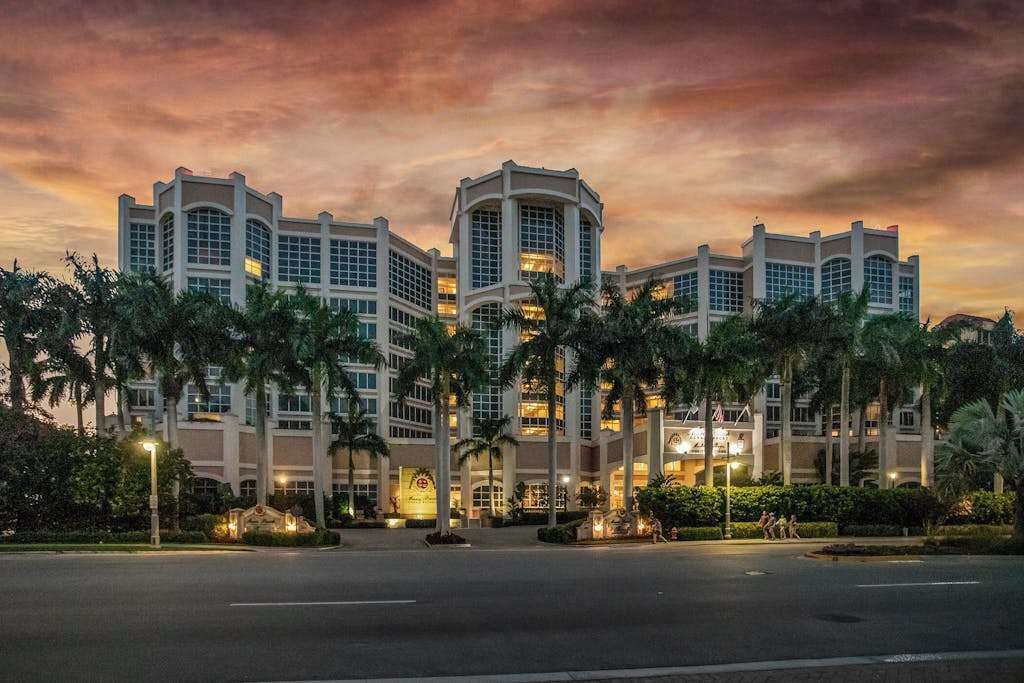 A multi-story hotel with a symmetrical facade, large windows, and a central entrance.
