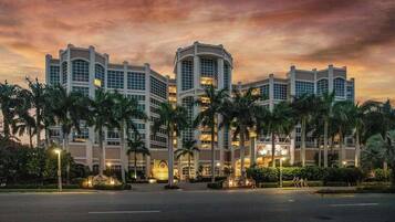 A multi-story hotel with a symmetrical facade, large windows, and a central entrance.