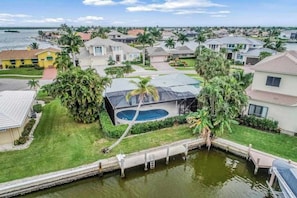 A residential area with houses, a swimming pool, and a dock.