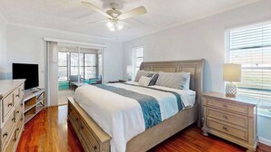 A bedroom with a bed, a television, a desk, and a window. - Palm-lined waterfront retreat with enclosed pool, inviting patio, & central AC (Rotonda West)