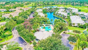 Un quartiere residenziale con case, una piscina e un campo da golf.