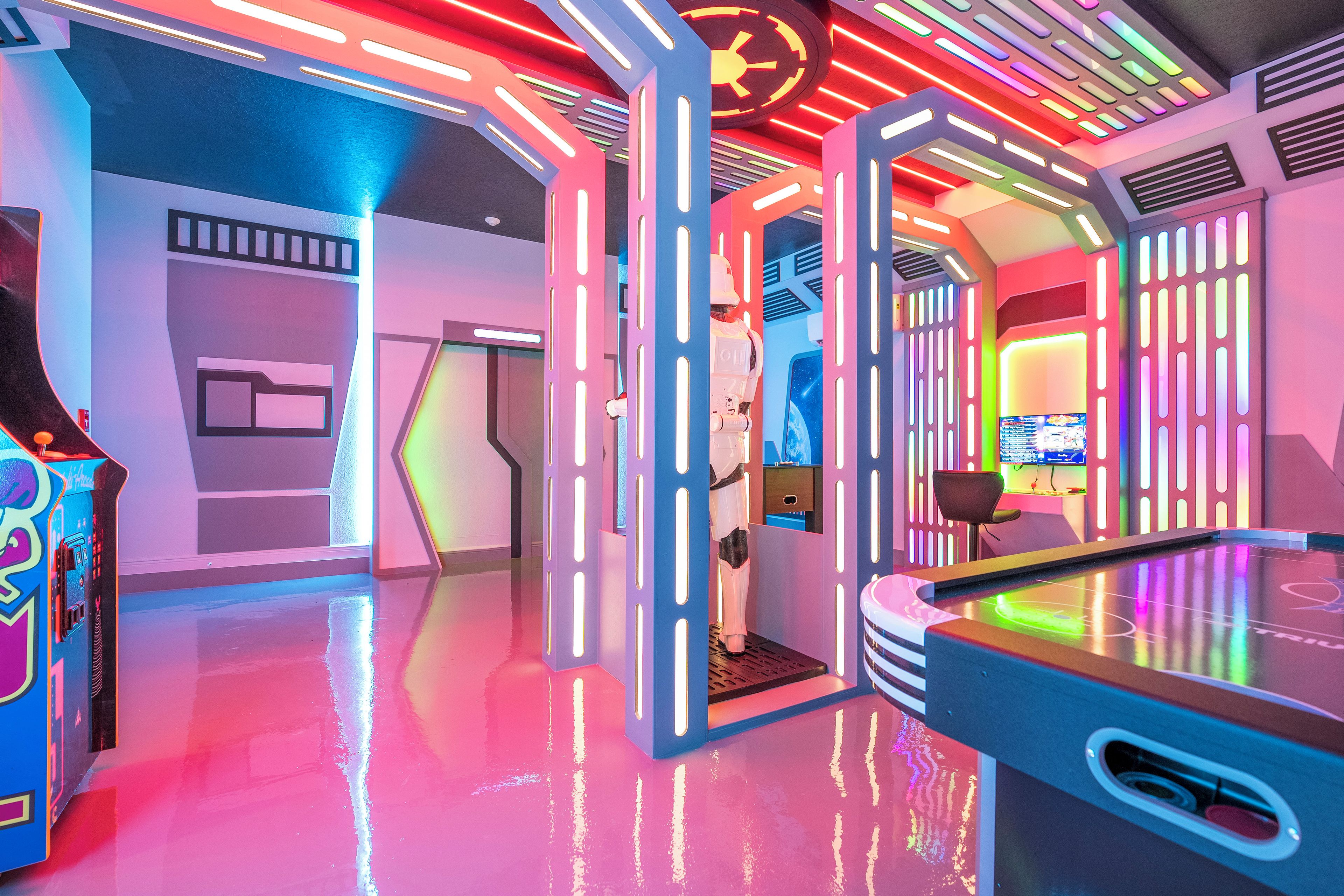 A brightly lit arcade with neon lights and a futuristic design.