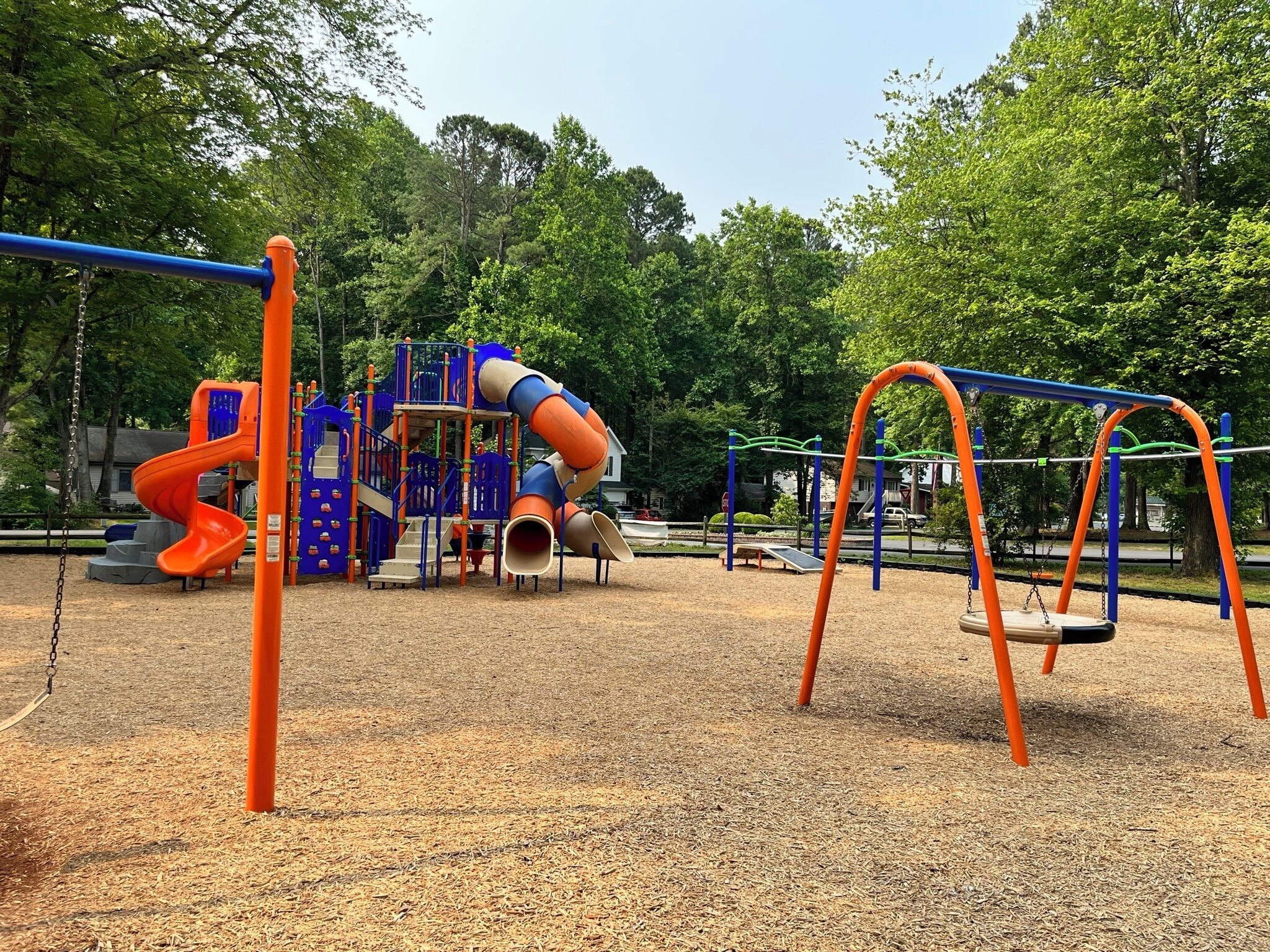 A playground with a slide, swings, and a climbing structure.