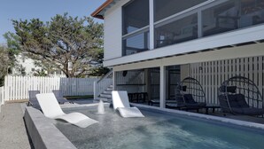A modern house with a swimming pool, outdoor seating, and a white fence. - Palmwood Haven | Private Pool, 2nd House From Sand! (Tybee Island)