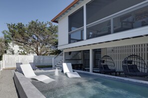 A modern house with a swimming pool, outdoor seating, and a white fence. - Palmwood Haven | Private Pool, 2nd House From Sand! (Tybee Island)