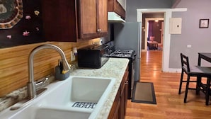 Una cocina con un lavamanos, estufa y armarios de madera.