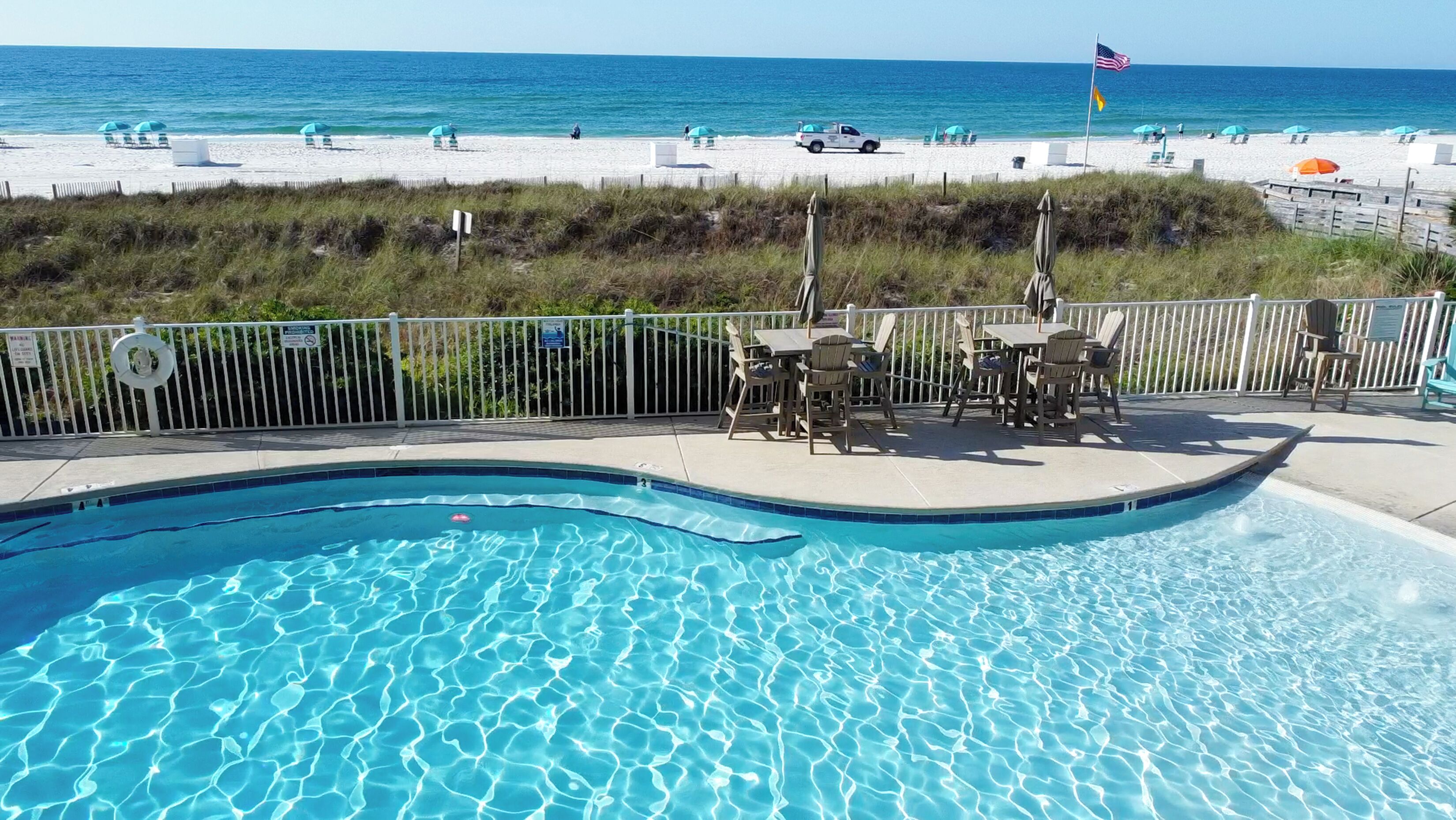 Une piscine avec vue sur la plage et l’océan.