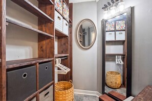A bathroom with wooden shelving, a mirror, and storage baskets. - Quiet 4BR Retreat Prefect for Families and Groups (Spartanburg)