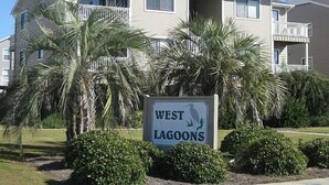 A multi-story building with a sign reading 'WEST LAGOONS.' - Beachside Condo / Linens Provided! By Williamson Realty (Ocean Isle Beach)