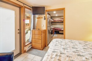A bedroom with a bed, a dresser, a TV, and a closet. - Hot Tub and Pool access|On Green Run|Free Shuttle (Breckenridge)