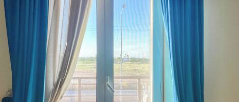 A room with a sliding glass door leading to an outdoor area.