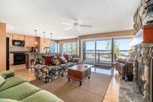 Lakefront condo with deck, gorgeous view, fireplace, & W/D