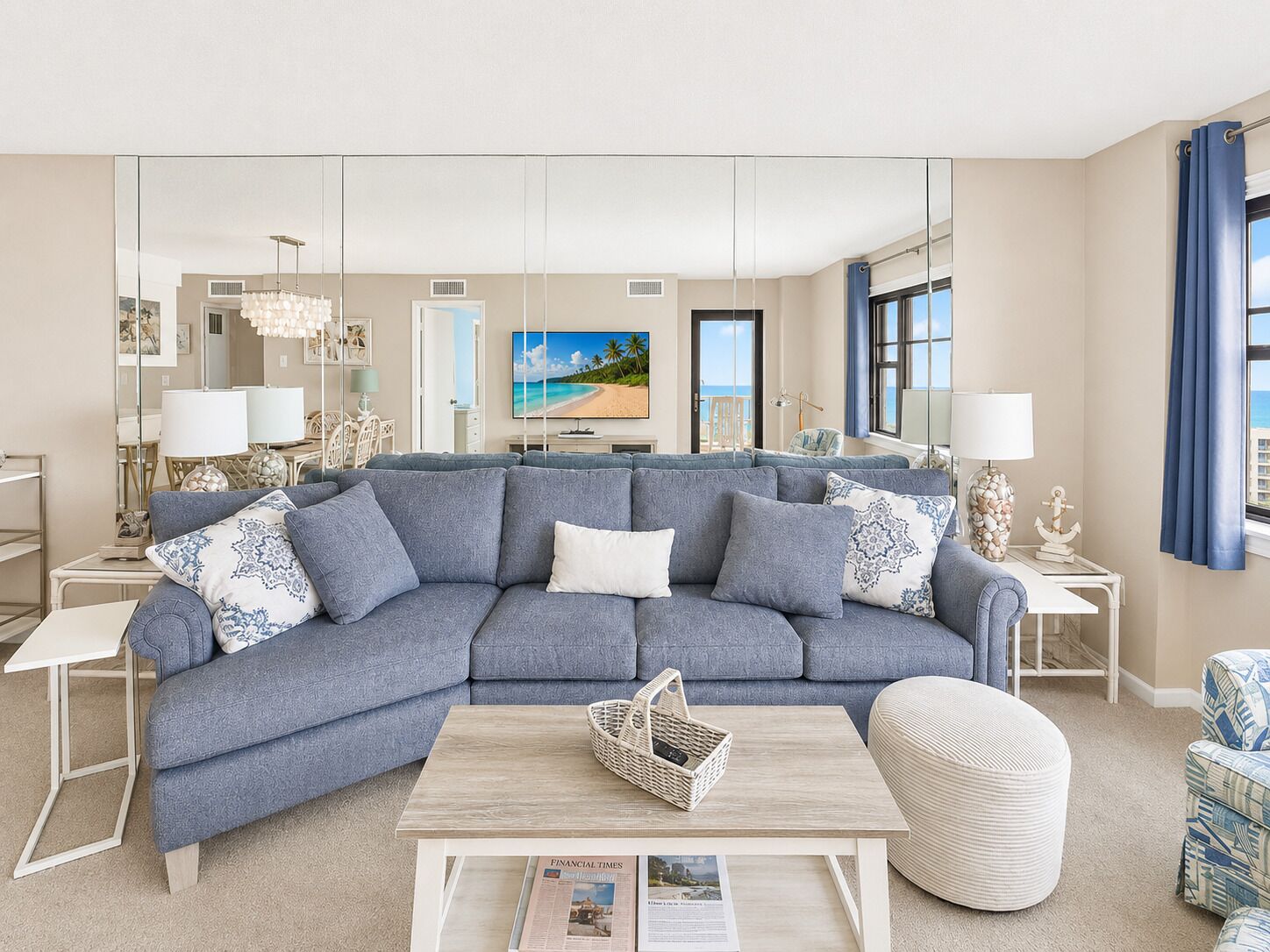 A living room with a large sectional sofa, a coffee table, and a television.