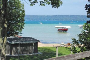 Beach - Lakefront cottage with a deck, grill, firepit, dock & partial AC (Glen Arbor)