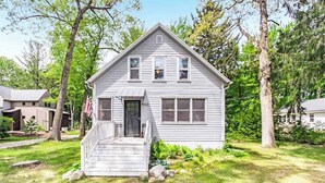A single-story house with a front porch, a garage, and a small front yard.
