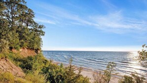 A coastal landscape with a beach, trees, and a clear sky. - Upper-level Duplex on Lake Michigan w/ patio, gas grill & WIFI (Coloma)