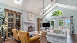 A living room with a fireplace, a television, and a sofa.