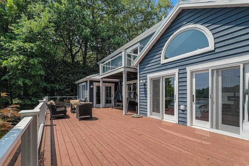 Serene lakefront retreat with an expansive deck, dock access, game room, & AC