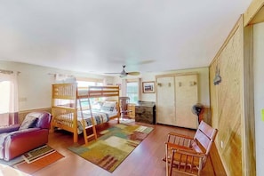A room with a bunk bed, a desk, a chair, and a wardrobe. - Remodeled, waterfront home on Portage Lake with dock & firepit - 2 dogs OK (Onekama)