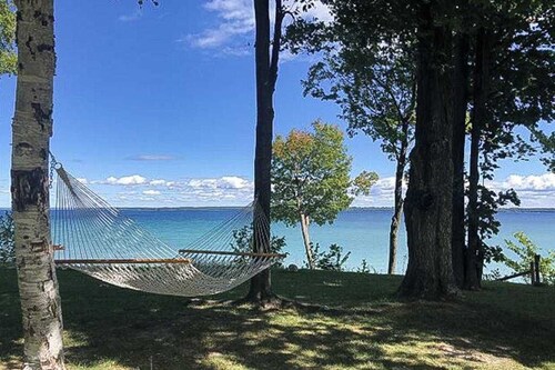 Dog-friendly secluded home near Suttons Bay with water views, firepit, fireplace