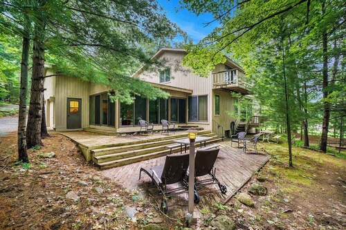 Two-story home with a patio, sunroom, balcony, & washer/dryer access