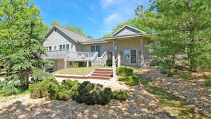 A two-story house with a front porch, a staircase, and a driveway. - Spacious lake access home with a washer/dryer, central AC, nearby tennis (Glen Arbor)