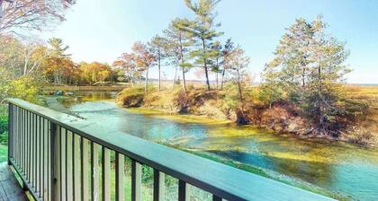 Riverfront condo with beach access to lake, fireplace, furnished deck & cable