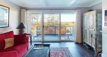 Riverfront condo with beach access to lake, fireplace, furnished deck & cable
