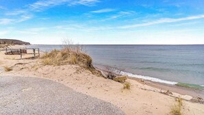 A coastal road with a metal guardrail, sandy dunes, and a clear view of the sea. - Secluded home w/ private grill, gas fireplace, full kitchen, and free WiFi (Arcadia)