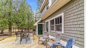 A deck with outdoor furniture, a green door, and a house with siding. - Secluded home w/ private grill, gas fireplace, full kitchen, and free WiFi (Arcadia)
