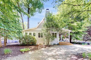 A house with a porch, a chimney, and a garden. - Newly-updated grand home in Union Pier‚Äôs Lakeshore Cottages with pool (Union Pier)