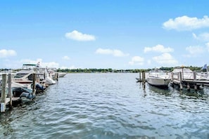 A marina with boats docked at wooden piers, calm water, and a clear sky. - Riverfront Home w/Private Deck/River Views/Free WiFi - Near Restaurants/Marina (Saugatuck)