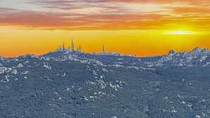 A mountainous landscape with a sunset.