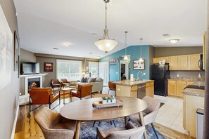 A modern kitchen with a central island, wooden cabinets, and a built-in stove. - Stylish dog-friendly retreat with furnished deck, pool, & firepits (Douglas)
