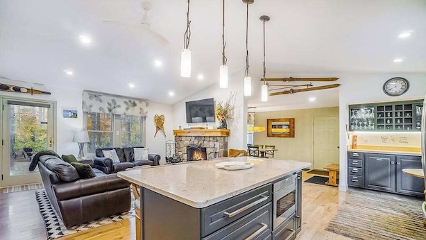 A modern kitchen with a central island, built-in appliances, and pendant lighting. - Stunning home w/ golf course views plus private deck near resort amenities (Thompsonville)