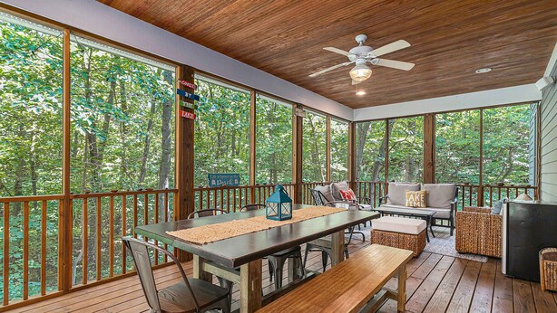 A covered outdoor area with a table, chairs, a sofa, and a ceiling fan. - The Oasis at Forest Beach | Updated house in New Buffalo with shared amenities (New Buffalo)