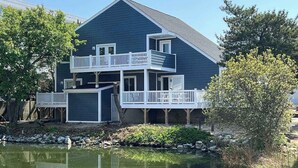 A two-story house with a balcony, a pond in front, and a wooden deck. - La Vista Bay Complex -A,B,C,D (Ocean City)