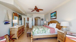 A bedroom with a bed, a ceiling fan, a dresser, a mirror, and a painting. - Oceanfront Belmont Towers Condo w/ Private W/D, Shared Pool, AC, Free WiFi (Ocean City)