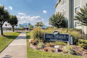 A sign for Bay Watch I Building A&B with a sidewalk and landscaping. - Baywatch I - 201B (Ocean City)