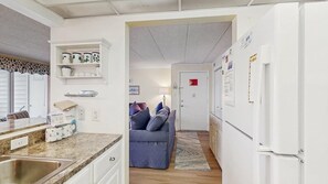 A compact kitchen with a sink, a built-in oven, and a refrigerator. - Thunder Island 34B Bay views at Convention Center (Ocean City)