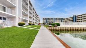 A multi-story residential building with a central courtyard, a water feature, and a pathway. - Thunder Island 34B Bay views at Convention Center (Ocean City)