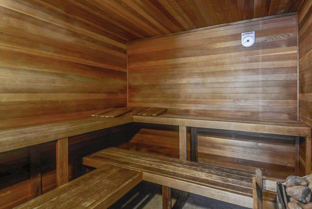 A wooden sauna with benches and a bench seat.