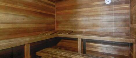 A wooden sauna with benches and a bench seat.