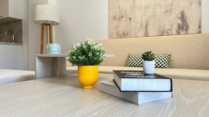 A modern living room with a sofa, a coffee table, a lamp, and two potted plants. - Fouka North Coast SA-4B-203 (Marsa Matrouh)