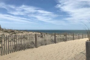A sandy beach with a wooden fence and a clear sky. - Bay Princess 403 - Just Breathe (Ocean City)
